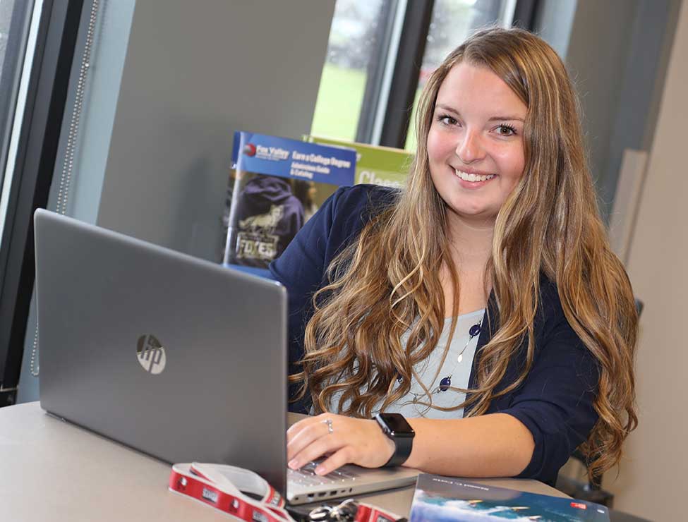 Student on laptop smiling